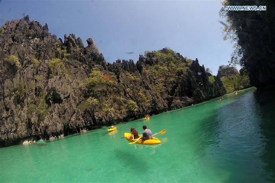 Vacationers take kayaks to tour around limestone formations in Palawan Province, the Philippines, Feb. 18, 2016. 