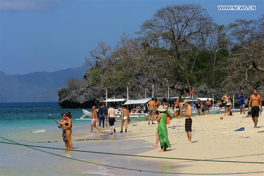 Tourists flock to a beach in Palawan Province, the Philippines, Feb. 18, 2016. 