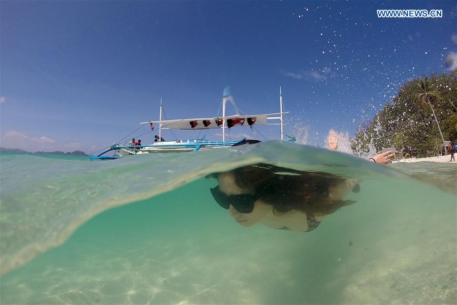 A vacationer swims in the sea in Palawan Province, the Philippines, Feb. 18, 2016. 