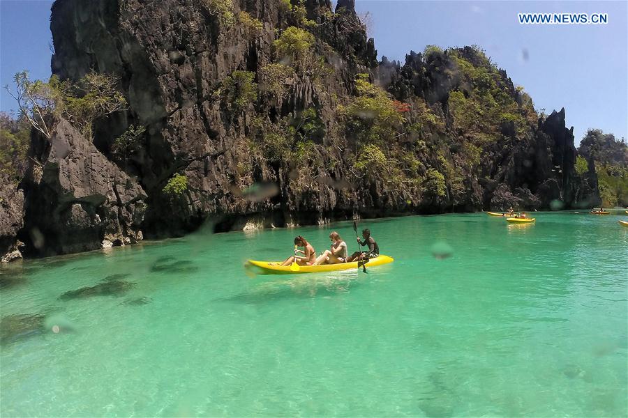 Vacationers take kayaks to tour around limestone formations in Palawan Province, the Philippines, Feb. 18, 2016. 