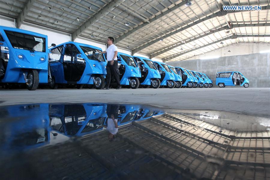 A production manager checks electric motor-powered tricycles or e-Trikes at a warehouse in Laguna Province, the Philippines, Feb. 24, 2016. 