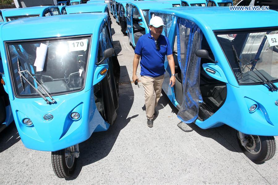 A production manager checks electric motor-powered tricycles or e-Trikes at a warehouse in Laguna Province, the Philippines, Feb. 24, 2016. 