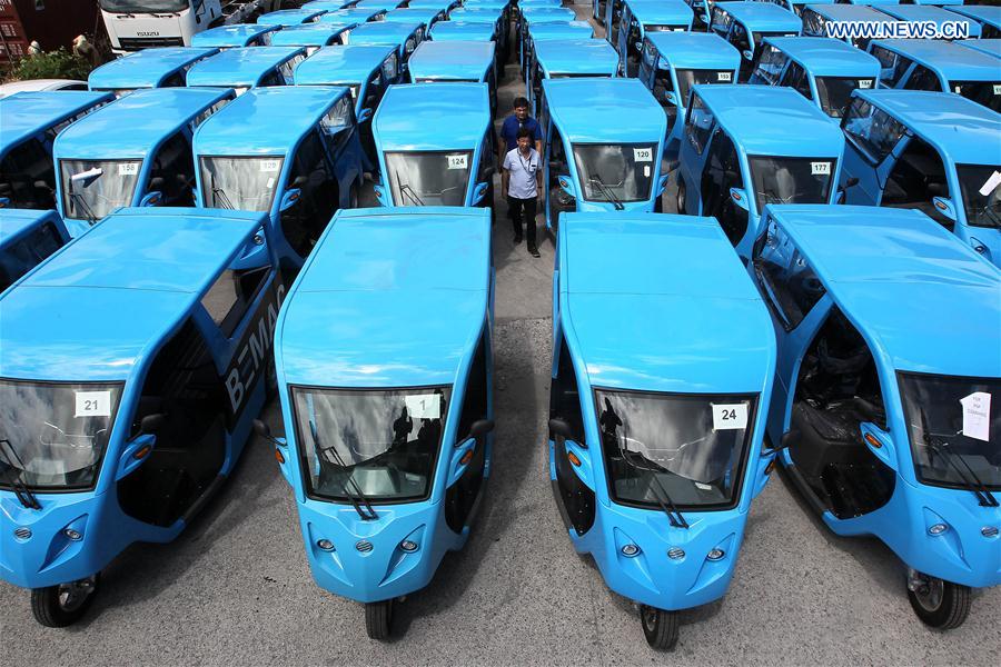 Production managers check electric motor-powered tricycles or e-Trikes at a warehouse in Laguna Province, the Philippines, Feb. 24, 2016.